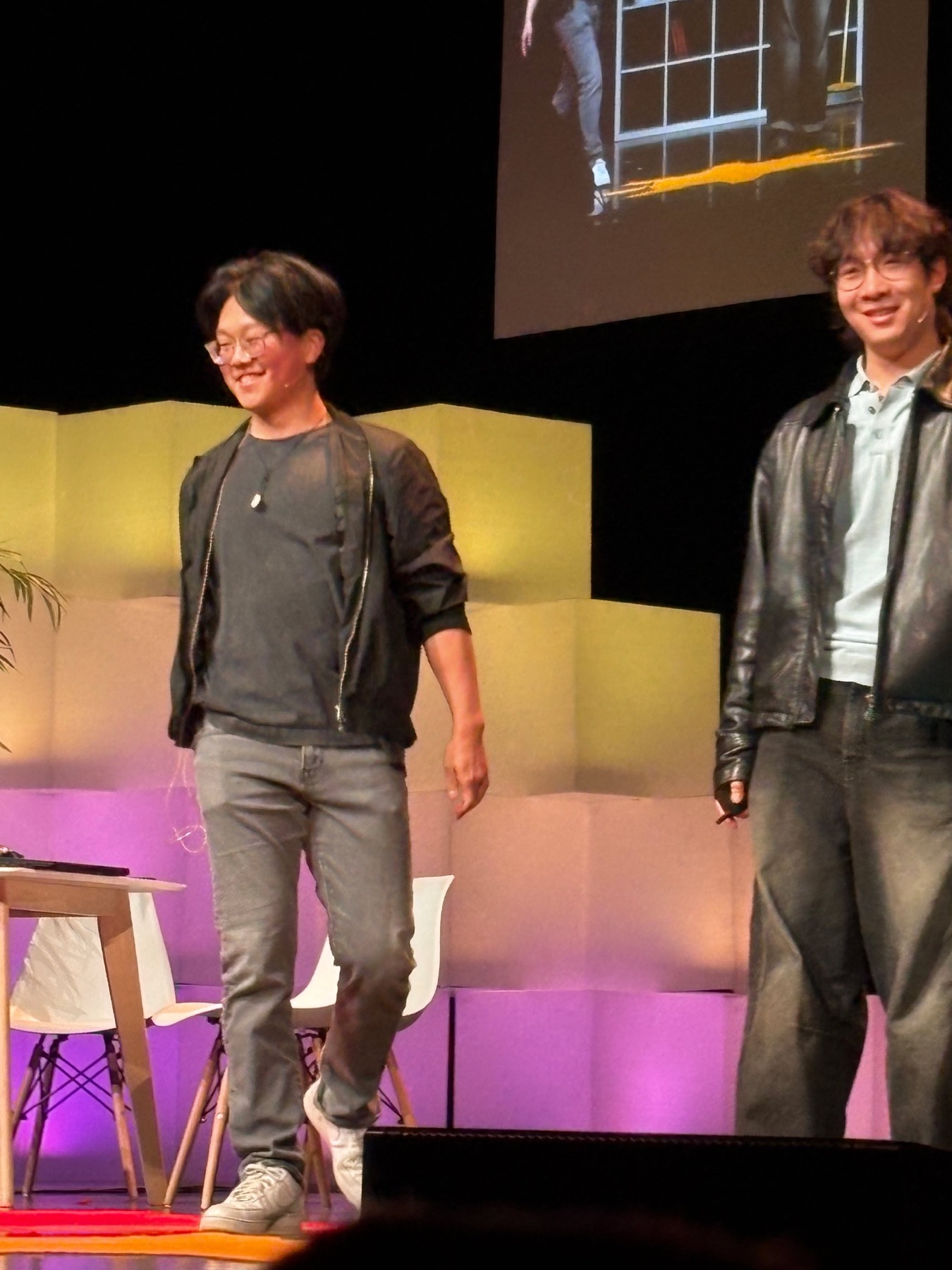 Symposium presenter under stage lighting